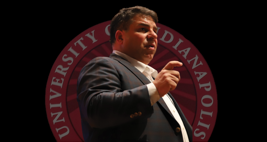 Robert Manuel at a Design DePaul event held on January 26,
2023, at the Holtschneider Performance Center, superimposed
over the logo of University of Indianapolis on the side of the
Greyhound Village which opened in 2016 during Manuels
tenure. 