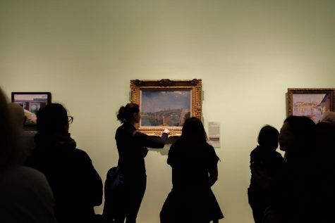 Museumgoers view The Seine Bridges at Asnieres by Van Gogh in the gallery. 