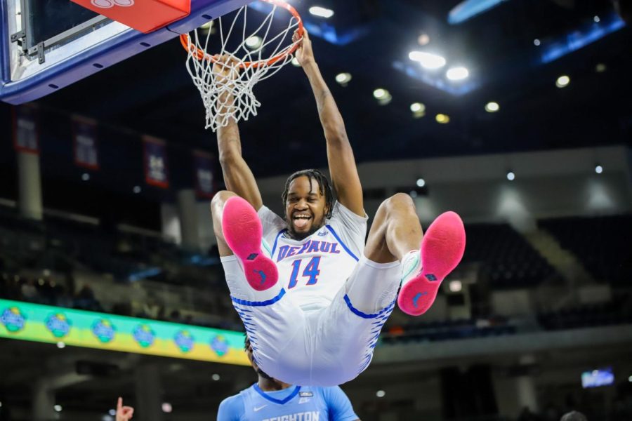 Nick Ongenda dunks during the Blue Demons’ 84-70 loss against Creighton on Saturday, March 4. Ongenda plans on entering his name in the 2023 NBA Draft, leaving DePaul after four seasons.