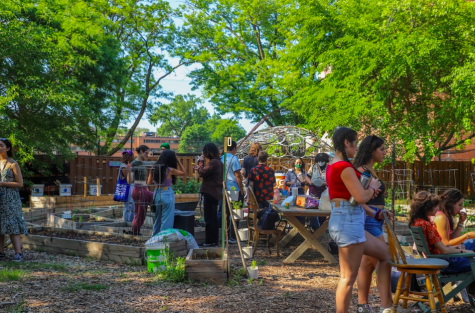 Students mingle around the DePaul Urban Gardeners (DUG) Fruity Party hosted in the groups garden to kick off Pride Month in Lincoln Park on Thursday, June 1. 