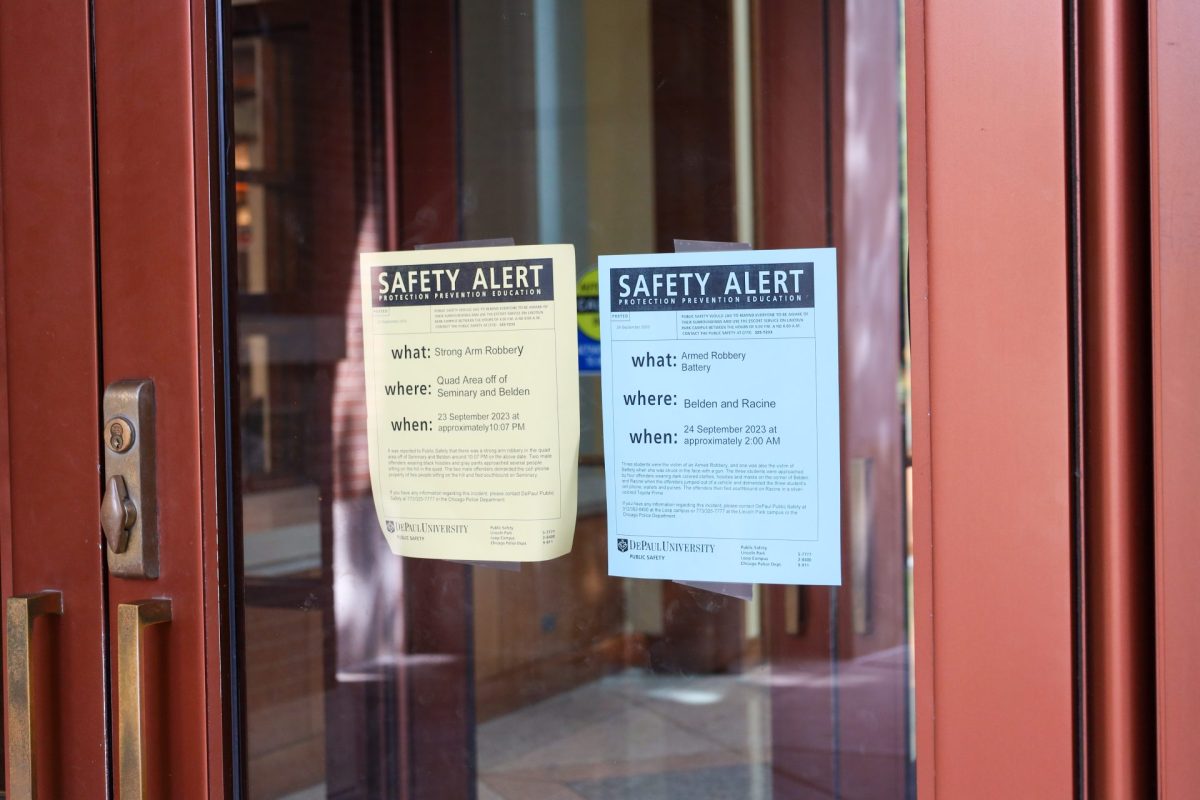 Public safety alert posters hang on the doors of the Richardson Library in Lincoln Park. When public safety alerts go out, posters are also hung to inform the DePaul community. 
