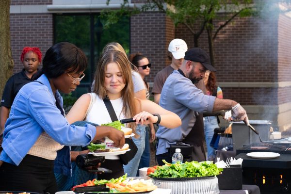 DePaul students top off their freshly grilled burger patties at the Back-to-School barbecue in Munroe Courtyard. 