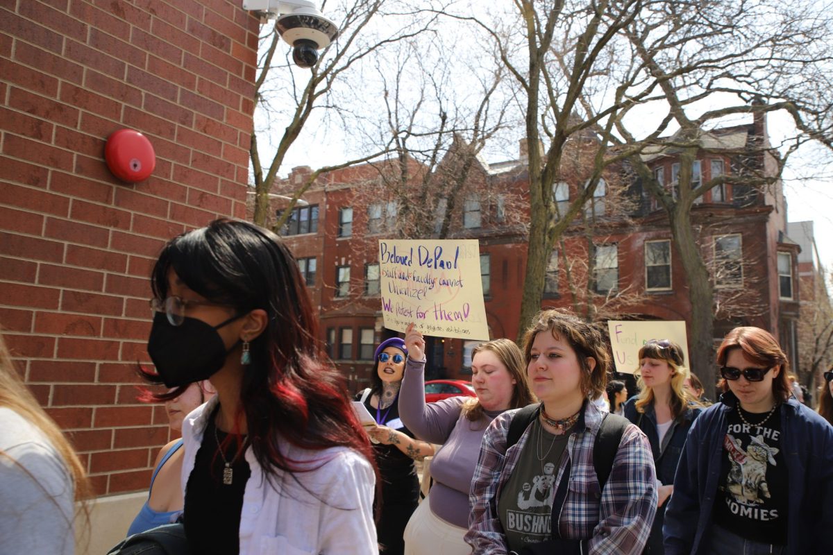 Students protest the university letting go of faculty and staff on Sheffield Ave. on April 10.