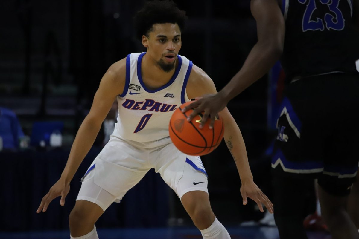 Freshman four-star recruit Zion Cruz plays defense against a Marian guard in Wintrust Arena on Nov. 1.