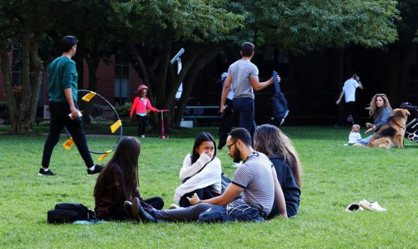 Students laugh while gathered on the Lincoln Park quad on Thursday, Sept. 14, 2023, in Chicago. Various other groups were playing field games like Spike Ball or studying.