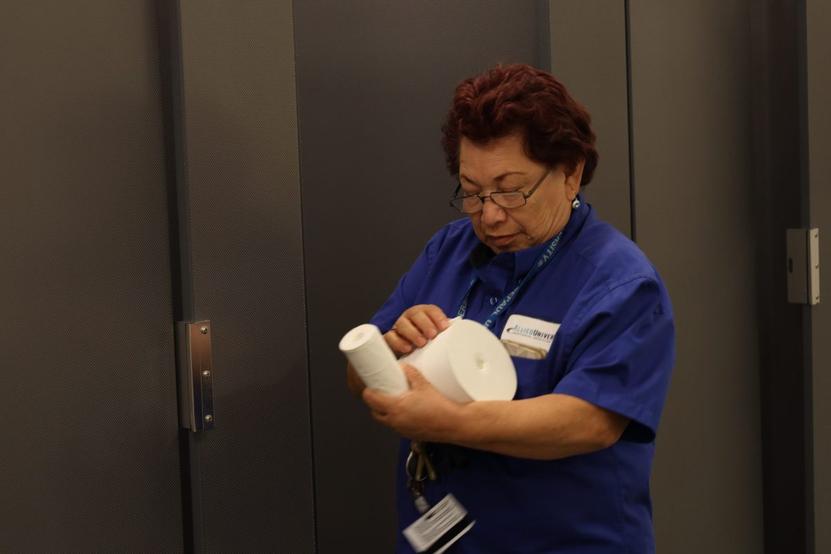 Maria Arvizo, a custodian at DePaul, cleans a mirror in the womens bathroom at OConnell Hall on Oct. 10. Arvizo is well known as Doña Maria for providing food to students and staff around the Latinx Cultural Center.