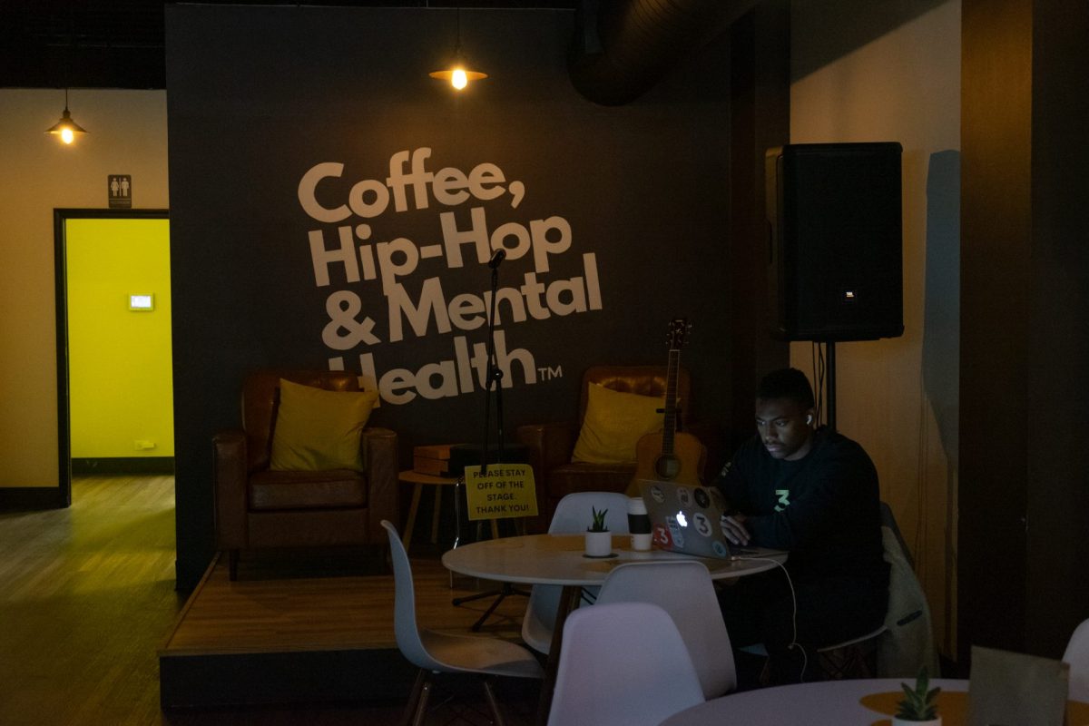 A customer works at the Coffee, Hip-Hop & Mental Health cafe in Chicago on Oct. 20, 2023. The coffee shop has a relaxing vibe with low-lighting and mellow hip-hop playing.