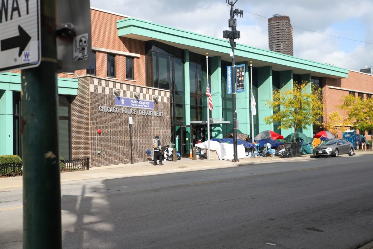 A temporary encampment sits outside the 19th District police station on Chicago’s North Side on Oct. 21, 2023. Several police stations are helping provide space for migrants and asylum-seekers, until more permanent solutions can be found.
