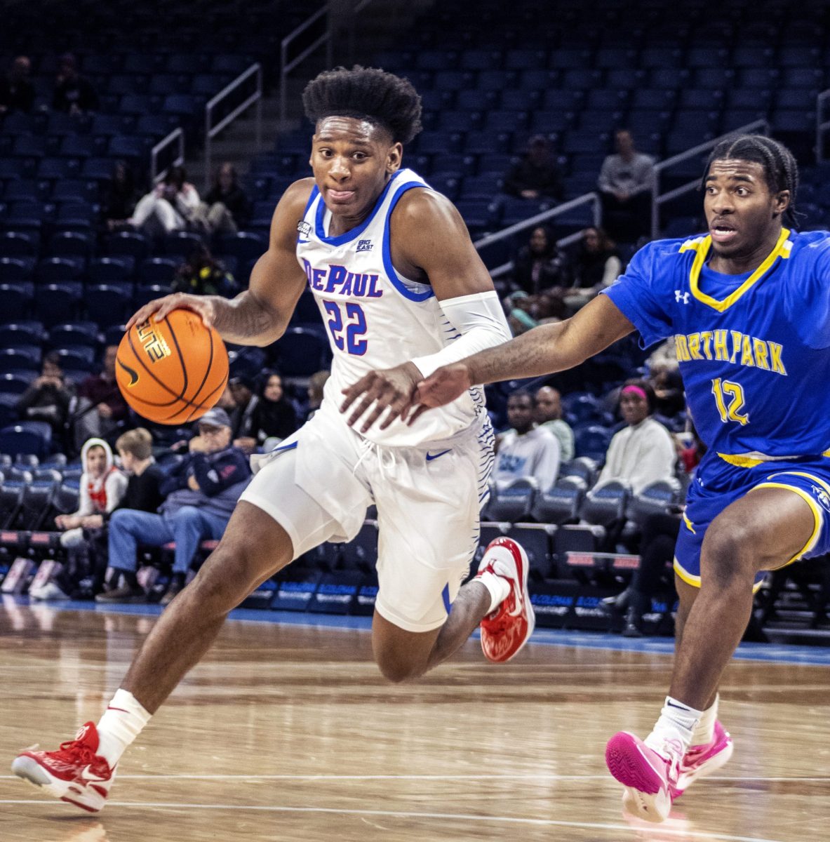 Sophomore guard Elijah Fisher drives to the basket in a exhibition game against North Park Thursday, November 2 at Wintrust Arena.
