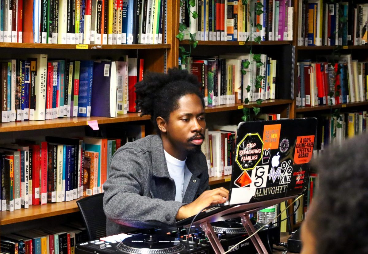 DJ Cymba, a host and event curator from the South Side of Chicago, plays music for those in attendance at the event.