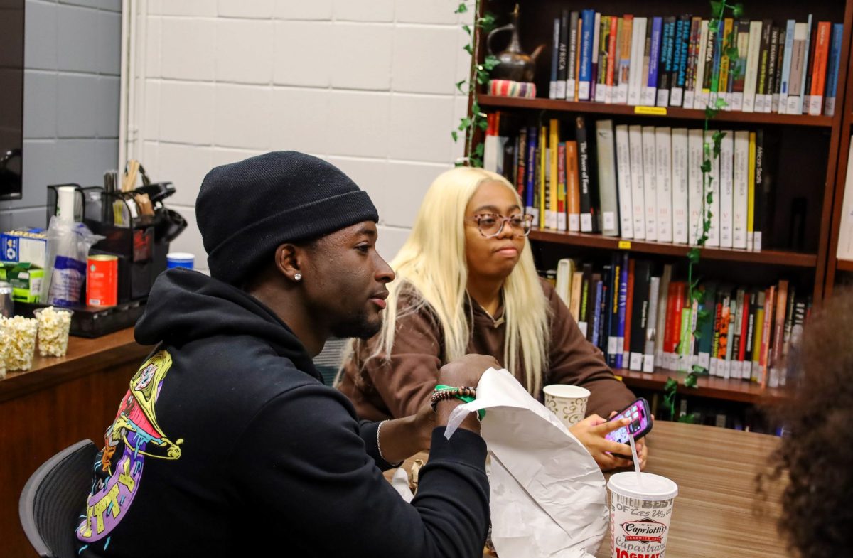 Kendryck Cotton (left) and Leeann Gladney (right) listen to DJ Cymba during Thursday night’s open house.

