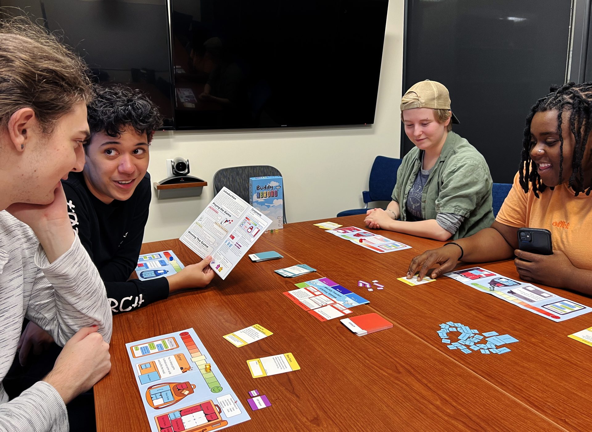 From left, Crane Benson, Silver MacAuley, Jules Mortensen and Ope Animashaun play the Buddy Abroad card game that is meant to help students acclimate to studying abroad.