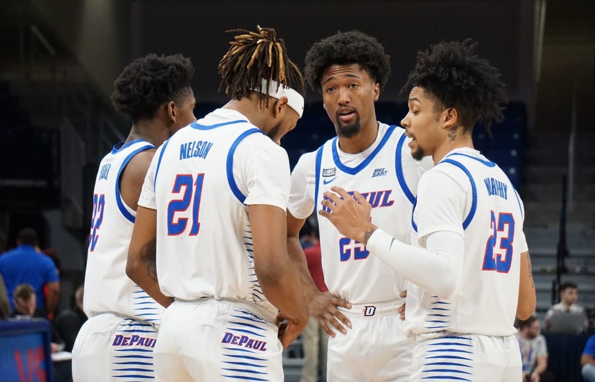 DePaul players Elijah Fisher, DaSean Nelson, Jeremiah Oden and Caleb Murphy huddle during a game against South Dakota, Nov. 14, at Wintrust Arena.