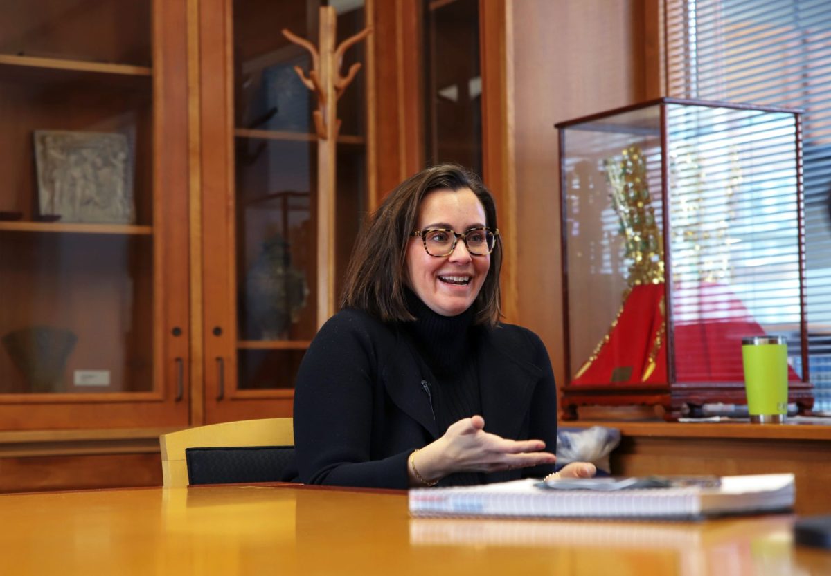 Megan Goldberg, associate professor of American politics at Cornell College sits at a desk in Mount Vernon, Iowa. 
