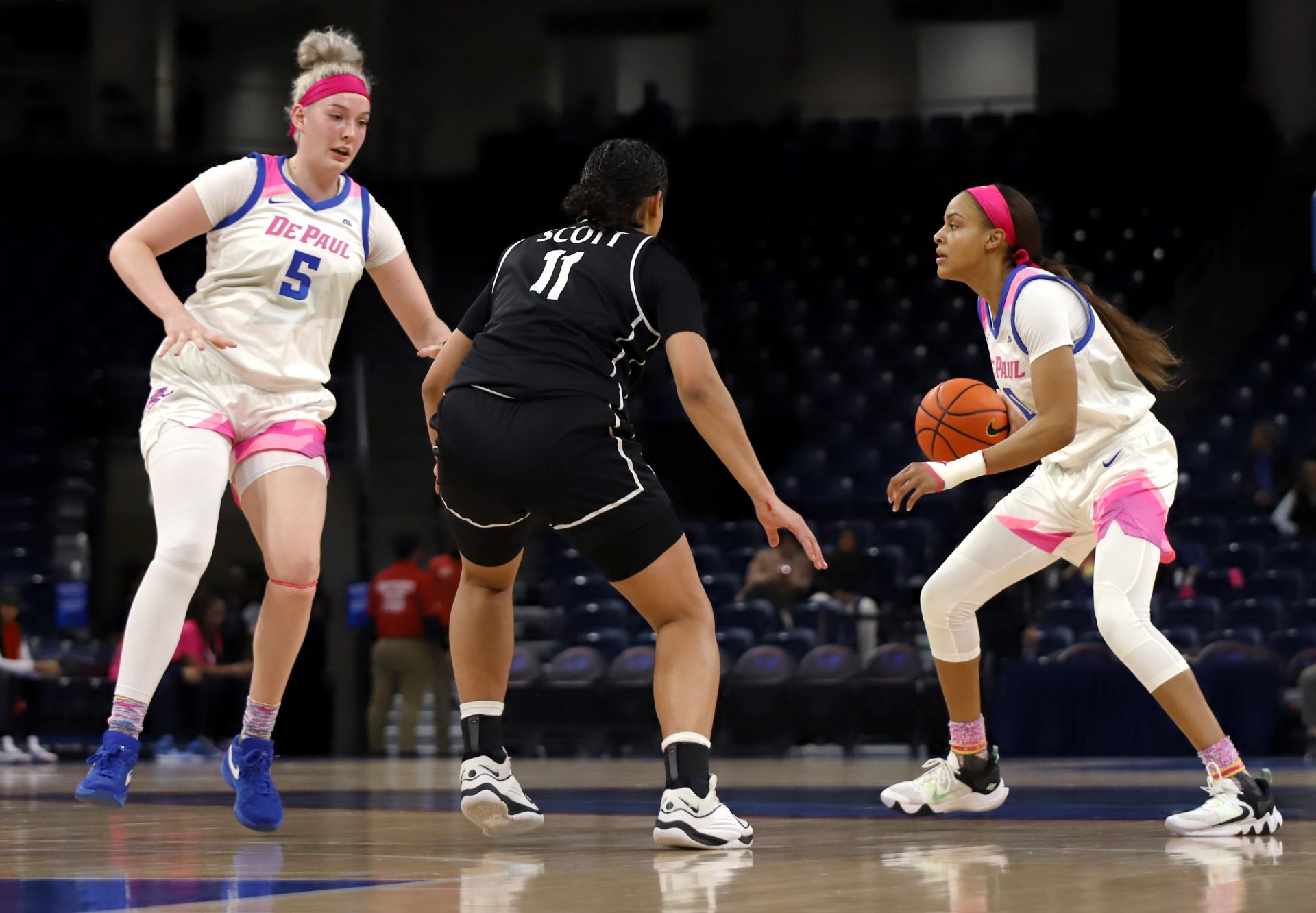 DePaul guard Katlyn Gilbert (No. 0) gets a screen from forward Brynn Masikewich (No. 5) in a game against Providence Feb. 7, 2024, at Wintrust Arena. The Blue Demon uniforms featured pink accents to raise awareness for the Kay Yow Cancer Fund.