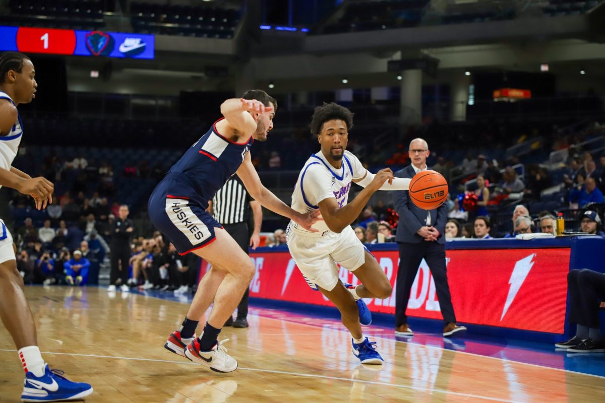 DePaul senior guard Jeremiah Oden dribbles towards the baseline in DePaul's match against UConn Feb. 14, at Wintrust Arena. Oden shot 1-6 from the field in 22 minutes.