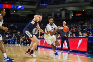 DePaul senior guard Jeremiah Oden dribbles towards the baseline in DePauls match against UConn Feb. 14, at Wintrust Arena. Oden shot 1-6 from the field in 22 minutes.