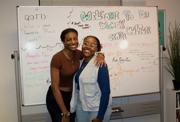 The Vice President of the Black Student Union Safia Poindexter, left, and Mya Wraggs, the president, pose for a portrait in front of white board filled with inspiring messages on Thursday, Feb. 8, 2024.
