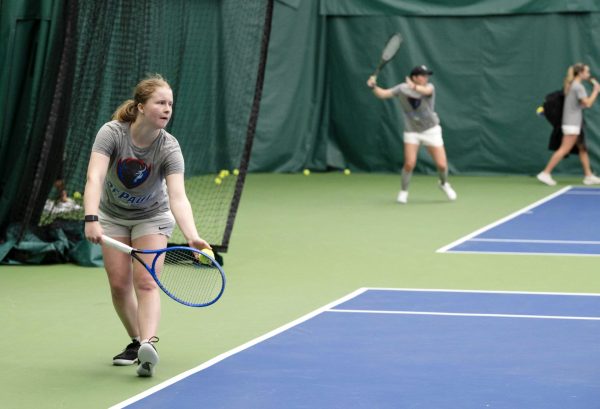 Eleanor Nobbs serves to teammate Eva Goncharov during their tennis practice on Wednesday, Feb. 7, 2024, at the Lakeshore Sports and Fitness in Chicago. Seven of the eight players on this year’s team are international students, including Hannah Smith who is from England and grew up with Nobbs.