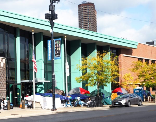 File - A temporary encampment sits outside the 19th District police station on Chicago’s North Side on Oct. 21, 2023. Police stations have been housing migrants as the government continues to find permanent solutions.