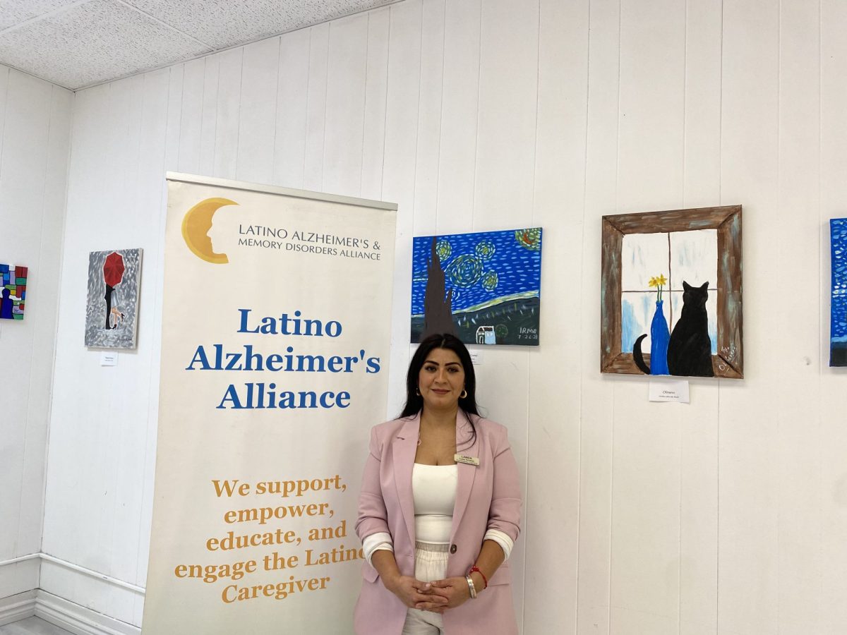 Luisa Ornelas stands in front of her students work at LAMDA Headquarters in Cicero, Ill., on April 10, 2024. Ornelas is passionate about sharing her love for art with her seniors. 