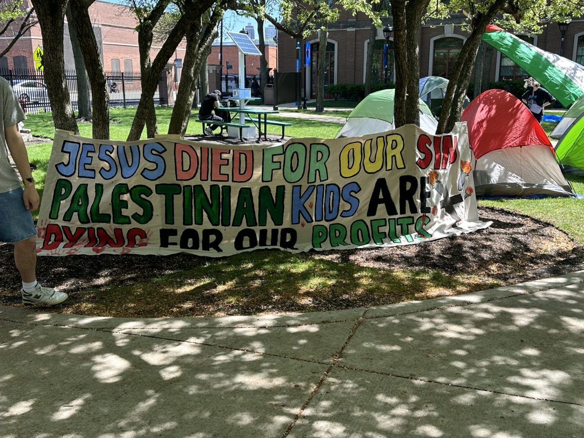 A sign reading "Jesus died for our sins. Palestinian kids are dying for our profits." on DePaul's quad shortly after protestors began an encampment for divestment, at 10:00 a.m.  