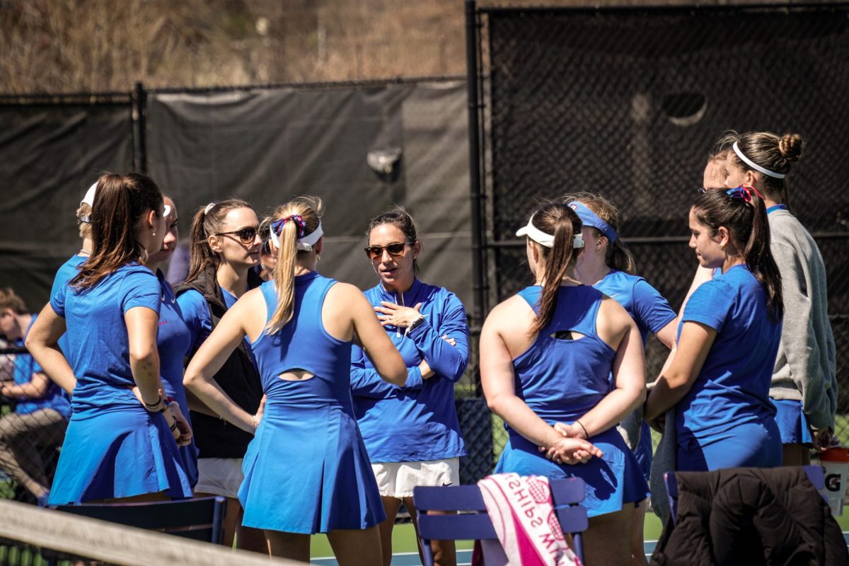 DePaul head coach Marisa Arce (center) speaks to her team after a loss to Xavier April 13, 2024, at XS Tennis Village in Chicago. DePaul lost the match 0-4 but entered the Big East Tournament as the No. 2 seed, with Xavier sitting at No. 1 in the conference.