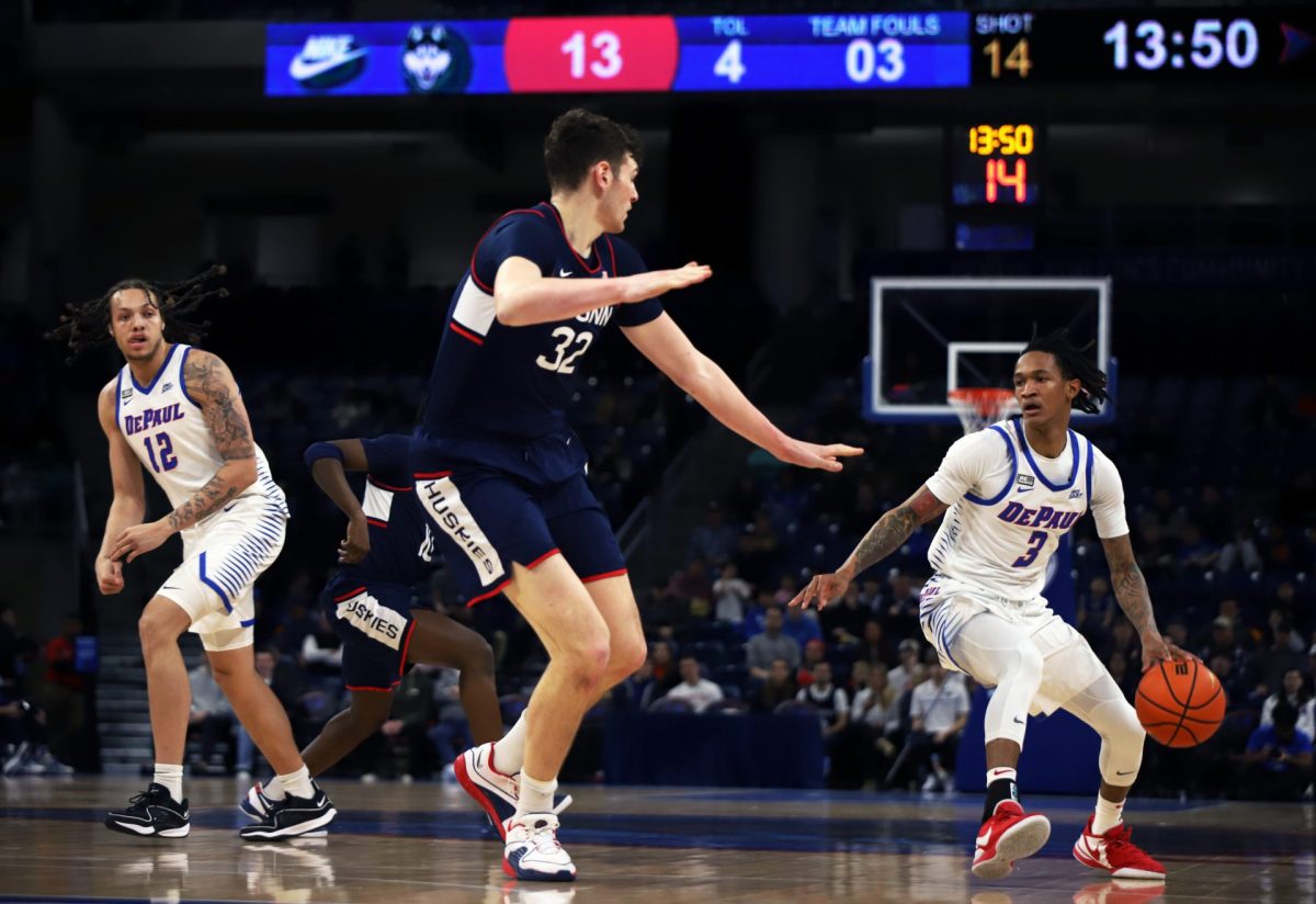 Donovan Clingan (No. 32) guards DePaul guard Jalen Terry (No. 3) in UConn's matchup with DePaul Wednesday, February 14, at Wintrust Arena.