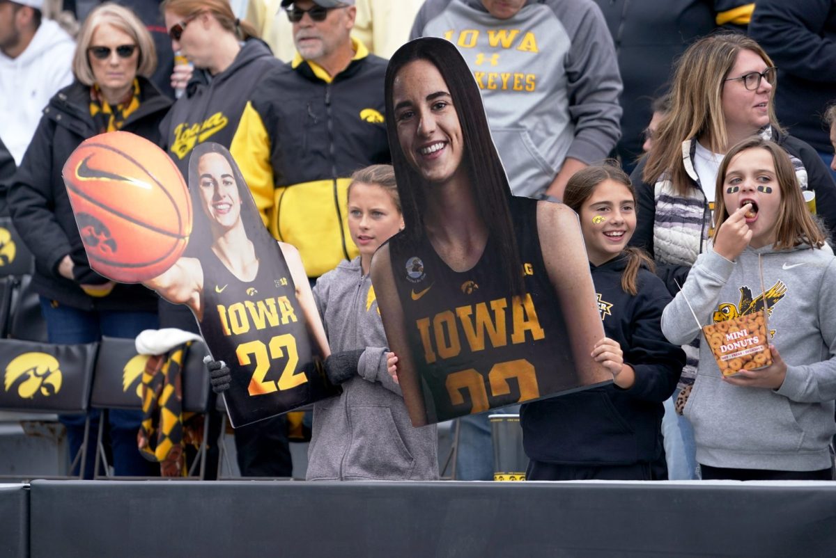 Fans+hold+images+of+Iowa+senior+superstar+Caitlin+Clark+at+the+DePaul-Iowa+game+in+Iowa+City+on+Sunday%2C+Oct.+15%2C+2023.+Clark+has+since+become+one+of+basketballs+biggest+stars+and+was+drafted+to+the+WNBAs+Indiana+Fever+on+Monday%2C+April+15%2C+2024.
