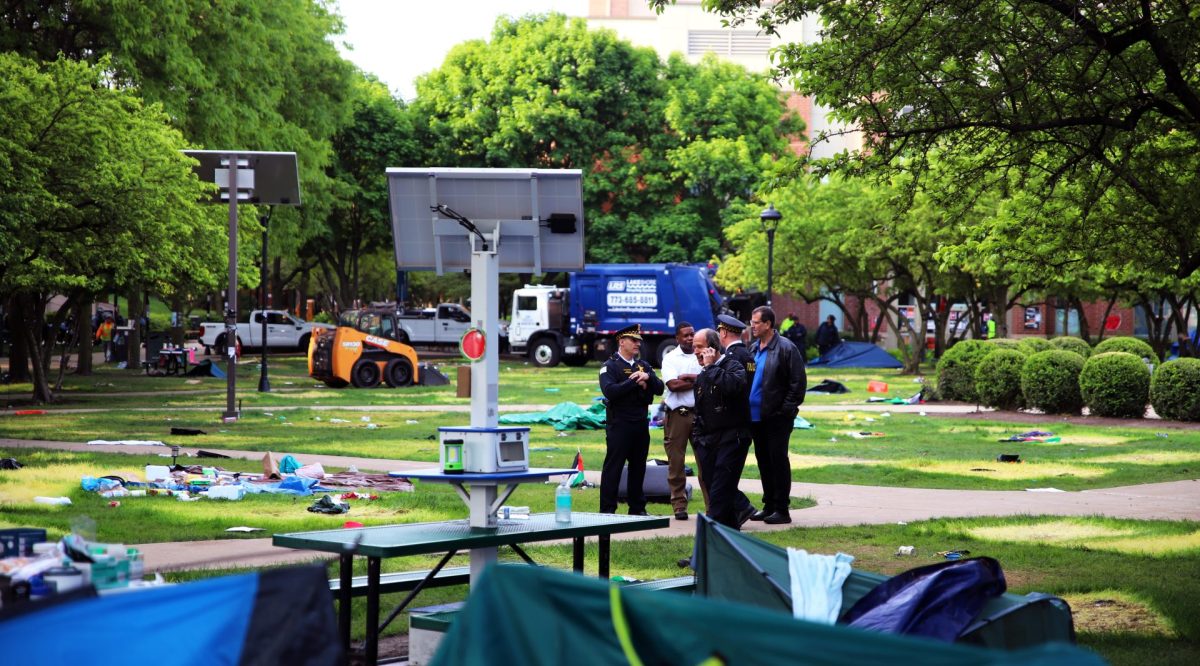 CPD and DePaul Public Safety director Bob Wachowski stand on the Quad after the encampment’s removal in the early hours on Thursday, May 16, 2024. A garbage truck and grounds equipment was brought in to begin repairs to the Lincoln Park Quad. 