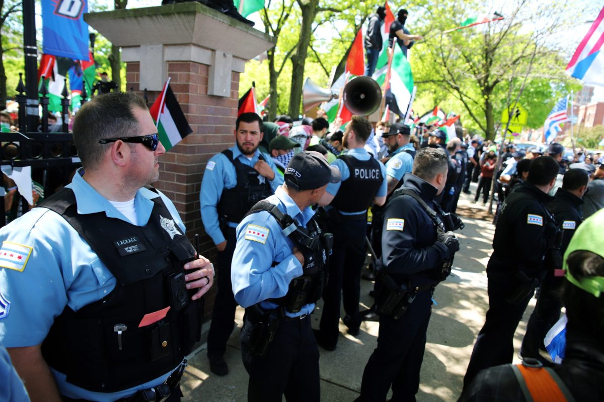 Chicago Police stand outside the Quad between protestors in the encampment and counter-protestors on Sunday, May 5, 2024, in Lincoln Park. There were only two minor injuries that occurred on Sunday. 