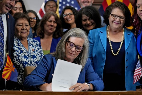 Arizona Gov. Katie Hobbs signs the repeal of the Civil War-era near-total abortion ban, Thursday, May 2, 2024, at the Capitol in Phoenix. Democrats secured enough votes in the Arizona Senate to repeal the ban on abortions that the states highest court recently allowed to take effect. (AP Photo/Matt York)
