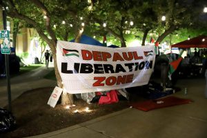 A sign that reads DePaul Liberation Zone hangs on the nortside of the Quad, on the night of May 1. Protestors have been encamped on DePauls quad since the morning of April 30. 
