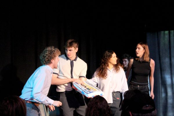 Members of the comedy sketch group “Go for Broke” begin their show with a skit about finding the board game that shares their name in an old, cluttered attic on Sunday, May 19, 2024. This was the group’s last show at the Bughouse Theater.