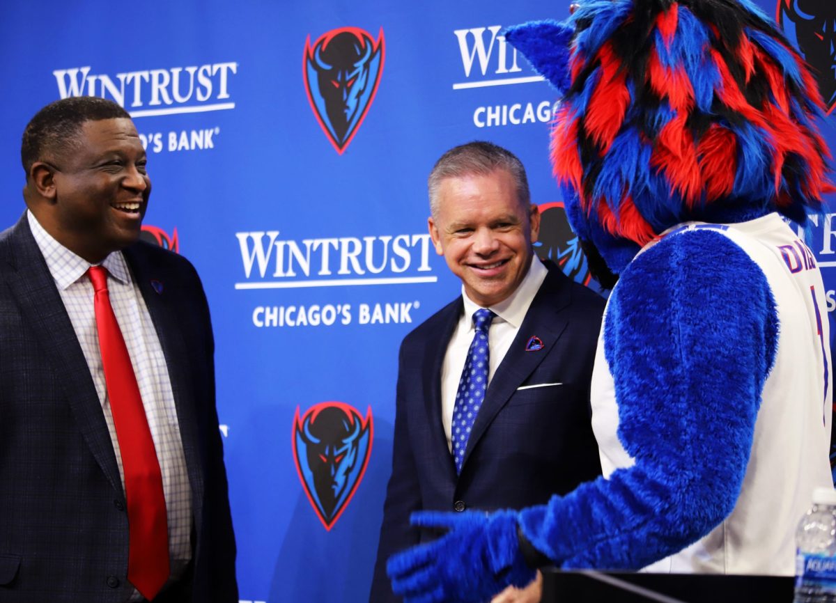 DePaul head coach Chris Holtmann, right, talks to Dibs with DeWayne Peevy on Monday, March 18, 2024, at Wintrust Arena during his welcoming press conference. Holtmann's plans for the team’s future was the main topic of discussion at the press conference. 