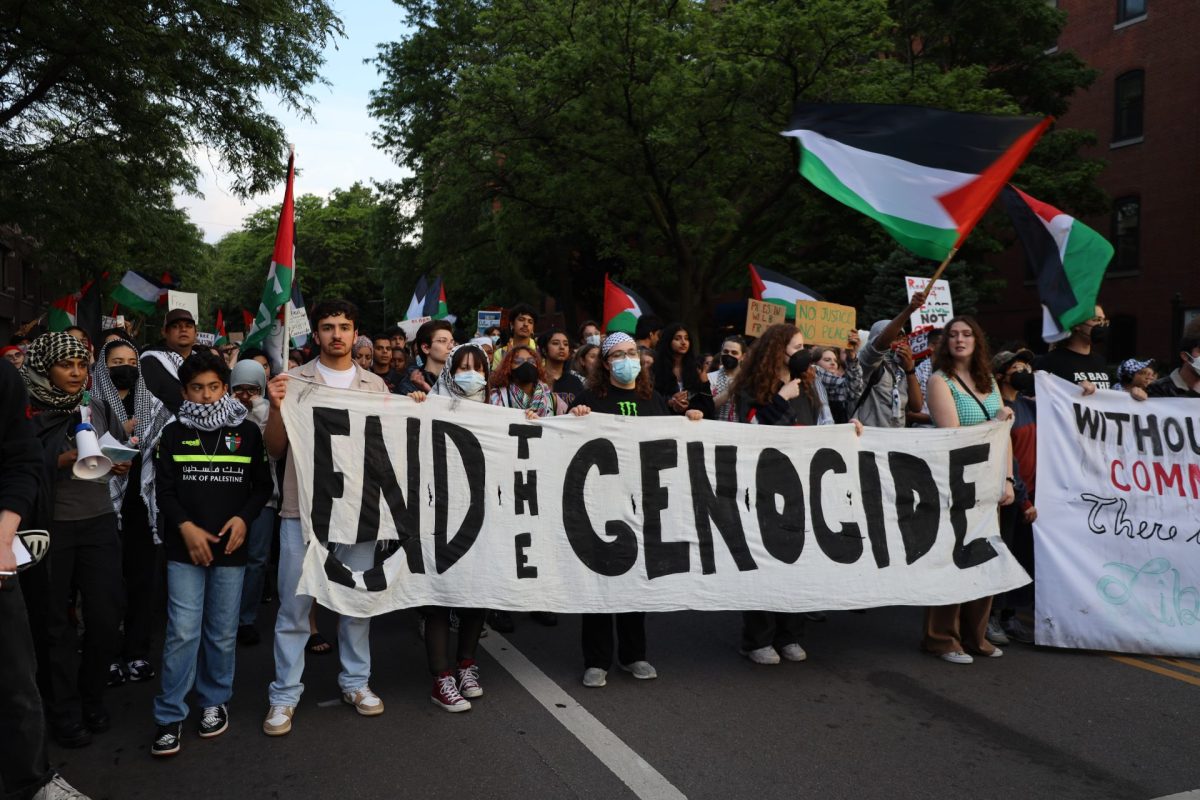 Pro-Palestinian protestors hold a banner saying End the genocide while marching down Sheffield Avenue May 16, 2024. The rally came after CPD and DePaul Public Safety cleared the student encampment earlier that day. 
