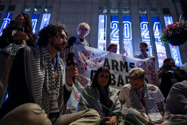 A group of uncommitted delegates and other pro-Palestinian supporters gather on Aug. 21, 2024, outside the United Center in Chicago. The group is holding a sit-in after being denied a Palestinian-American speaker at the DNC. 