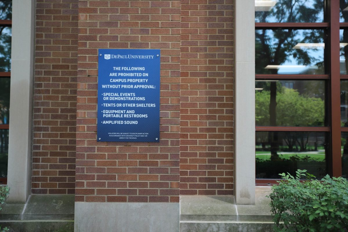 A sign hangs on the side of the John T. Richardson Library in Lincoln Park, Chicago, on Aug. 25, 2024. The sign reads out new demonstration policies on campus. 