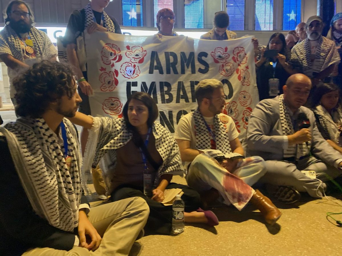 About a dozen delegates and other convention-goers have begun a sit-in in front of the United Center, on Aug. 21, 2024. 