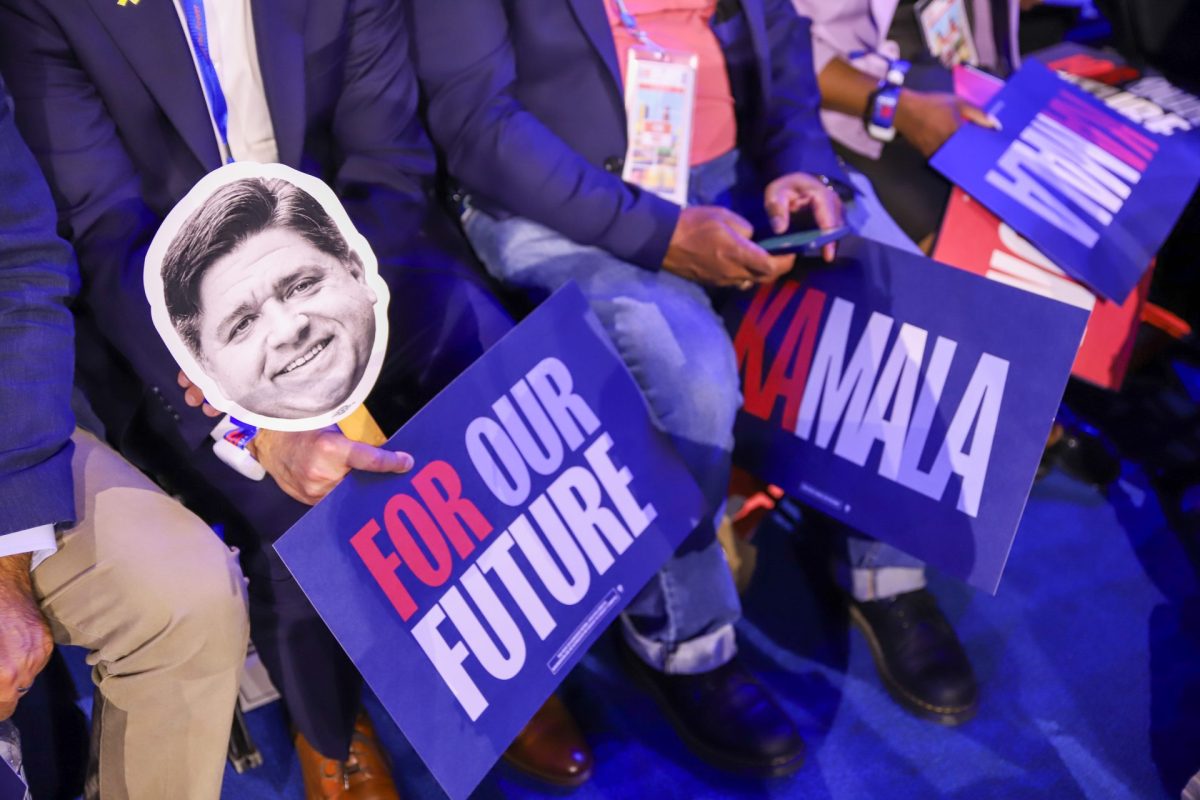 Illinois delegates hold signs supporting Kamala Harris and Ill. Gov. JB Pritzker, on Aug. 20, 2024 at the United Center. 