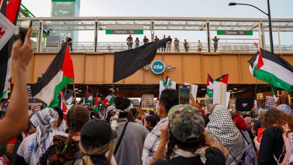 Protestors wave Palestinian flags as they approach Damen Station at Union Park in Chicago on Thursday, August 22, 2024, during the Coalition to March on the DNC.