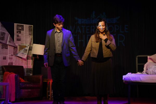 Actors Erick K. Rodgers and Rebeca Aleman stand holding hands on stage during the play, "The Delicate Tears of the Waning Moon" at Instituto Cervantes, Sept. 13, 2024. 