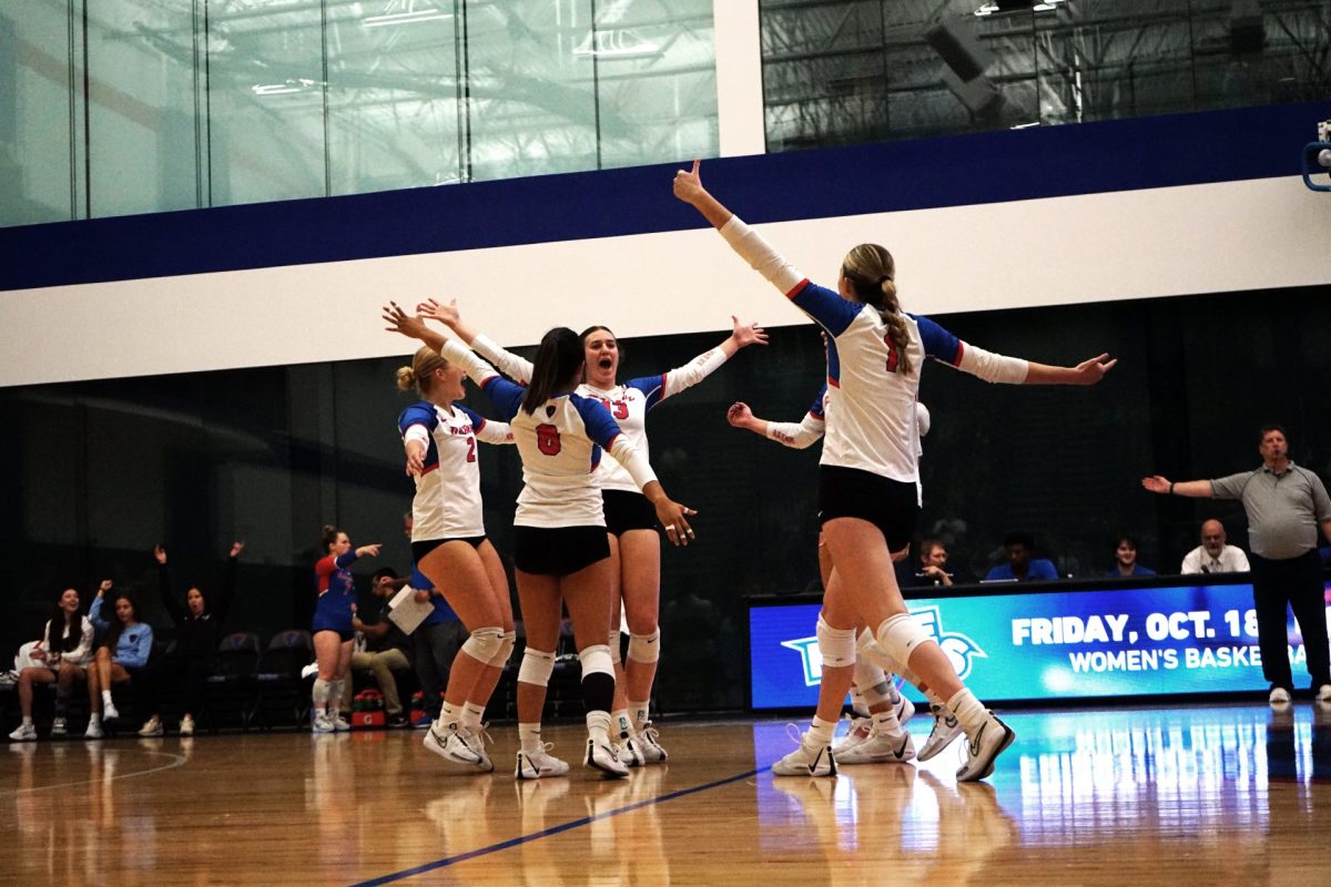 DePaul volleyball players celebrate on the court on Friday, Sept. 21, 2024, at McGrath-Phillips Arena. DePaul played against the UIC Flames in the Chicago Cup. 