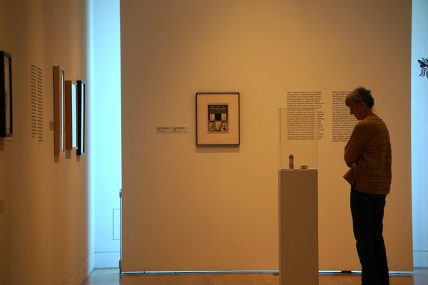 A patron observes a piece by Edgar Miller at DePaul Art Museum's new exhibit on Thursday, Sept. 26, 2024. Miller was one of Chicago's most prominent artists during the 1930s.