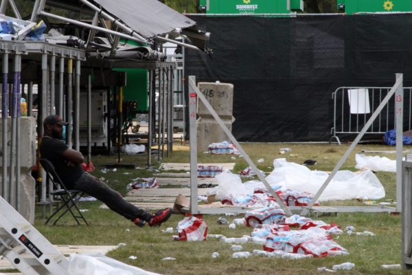 A volunteer clean-up member rests in the center of Douglass Park on Monday, Sept. 23, 2024. Riot Fest is held in Douglass Park for a total of three weeks, including the set-up and deconstruction of the festival grounds.