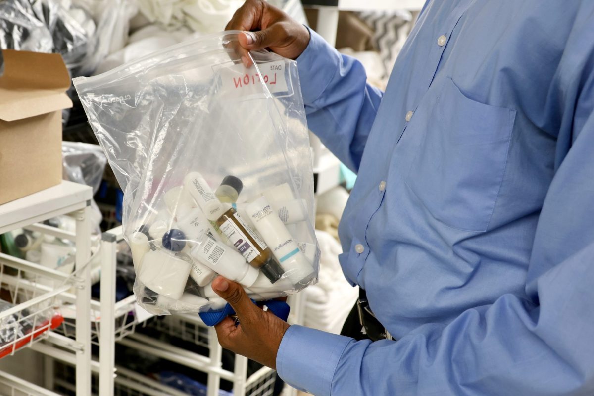 A worker holds up a personal hygiene kit, which contains of pre-packaged single-use items, on Friday, Sept. 20, 2024, at the Lincoln Park Community Services shelter. Illinois will soon ban single-use plastic bottles from being distributed inside hotel rooms, in an attempt to curb plastic waste.