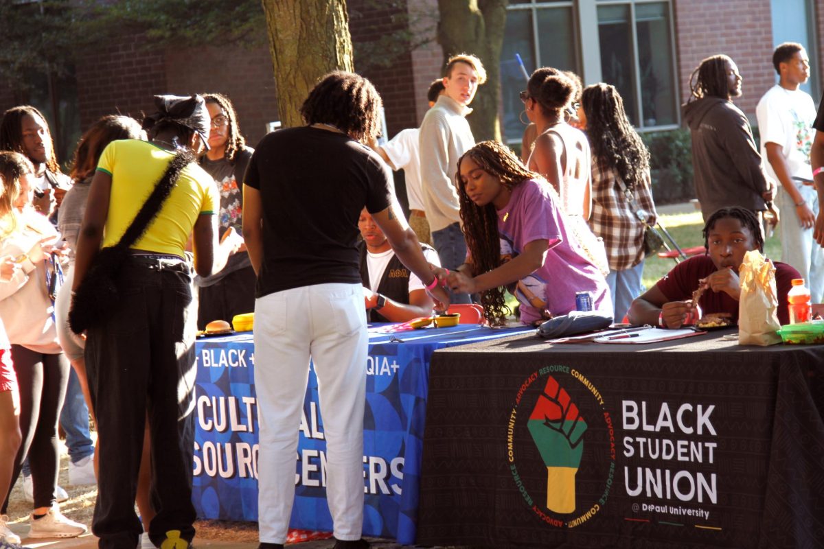 Black Student Union leadership members greet students and enjoy all Black Cultural Center’s cookout offers on DePaul’s Quad in Lincoln Park on Friday, Sept. 13, 2024. There were lawn games, obstacle courses and a bouncy boxing ring.  