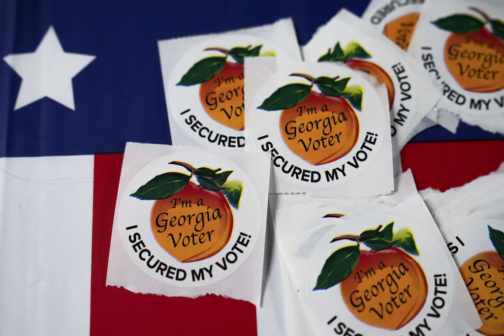 Stickers lay on a table inside a polling place, Tuesday, Nov. 5, 2024, in Atlanta. (AP Photo/Brynn Anderson)