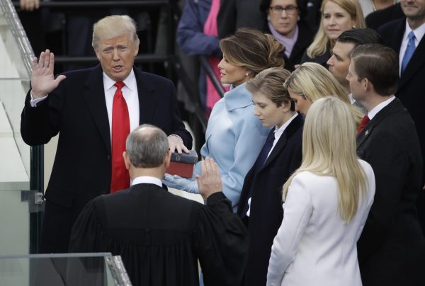 Donald Trump is sworn in as the 45th president of the United States by Chief Justice John Roberts as Melania Trump looks on during the 58th Presidential Inauguration at the U.S. Capitol in Washington, Friday, Jan. 20, 2017..