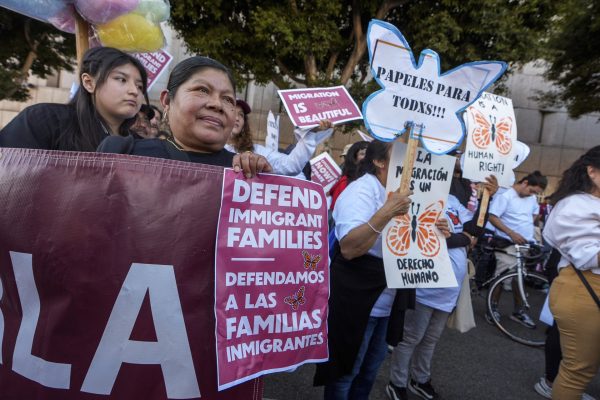 Members of Coalition for Humane Immigrant Rights (CHIRLA) join immigrant rights and social justice organizations and migrant workers in a march for "International Day of Action and Solidarity with Migrants" in front of The Metropolitan Detention Center, a U.S. federal prison in downtown Los Angeles on Wednesday, Dec. 18, 2024. 